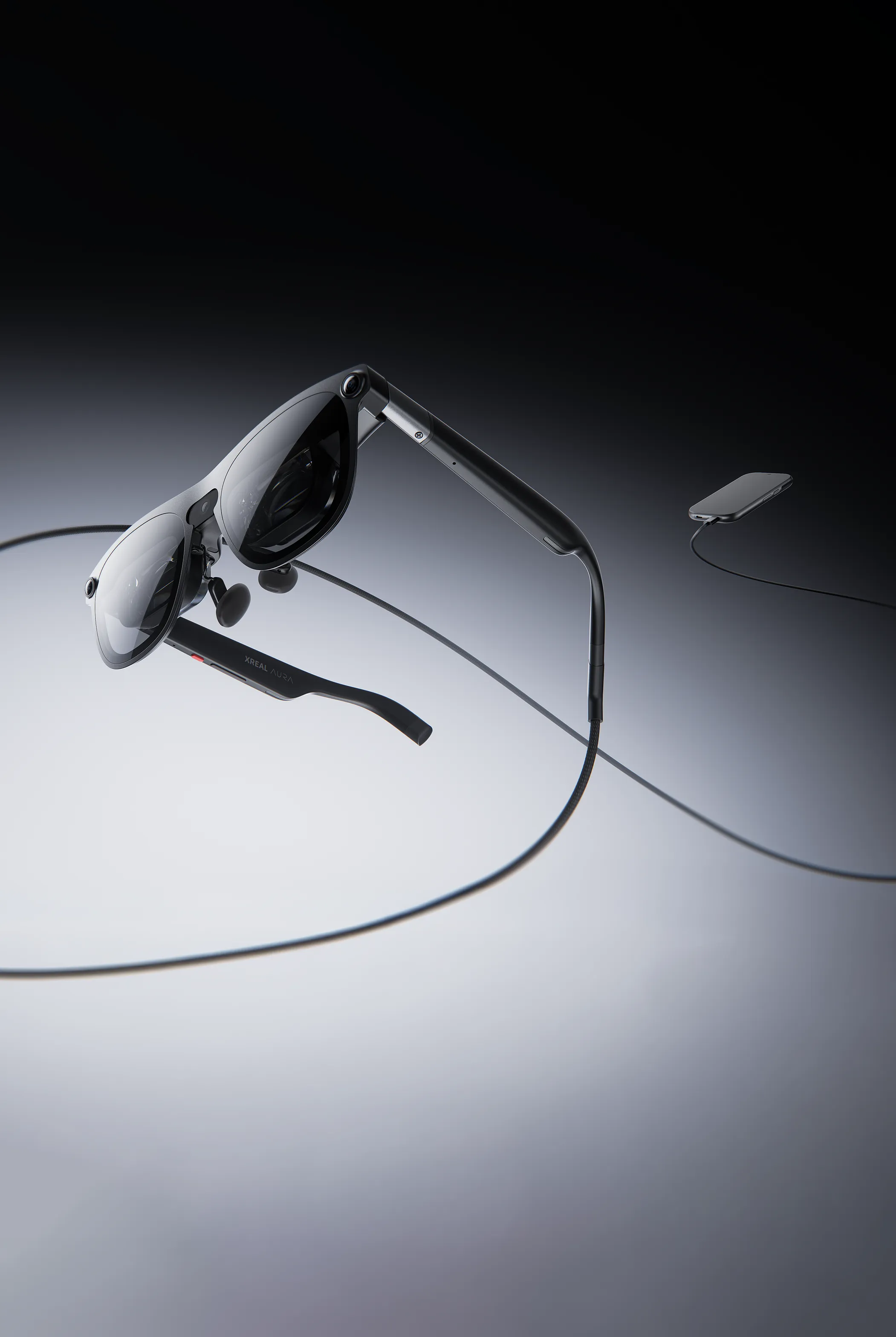 A person wearing the XREAL Aura XR glasses